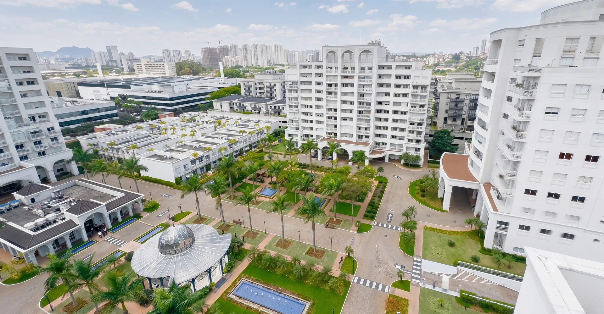 Vista aérea do Condomínio Villa Lobos Office Park, com os prédios, jardins e a cidade de São Paulo ao fundo
